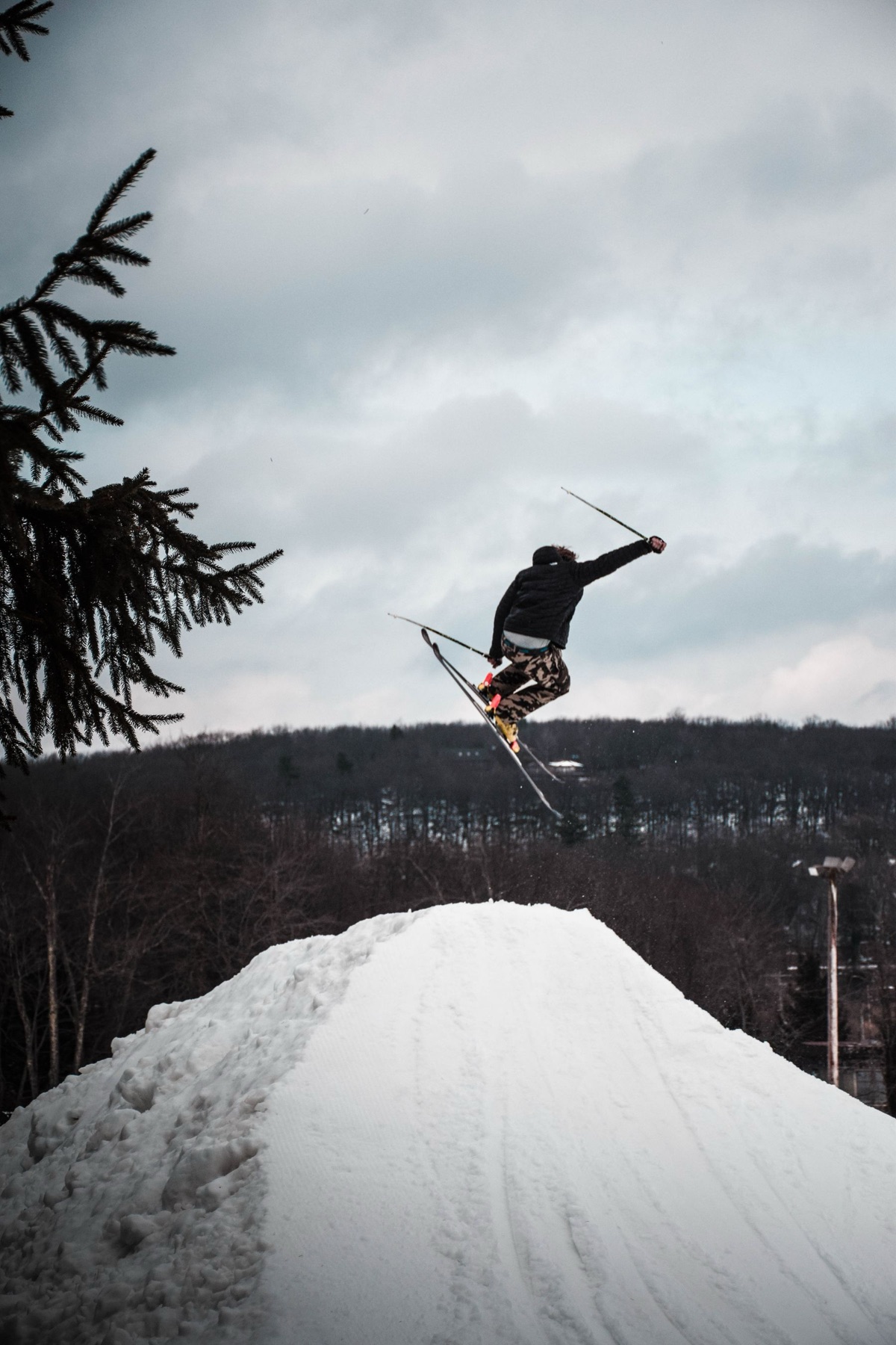 A skier in the air over a kicker